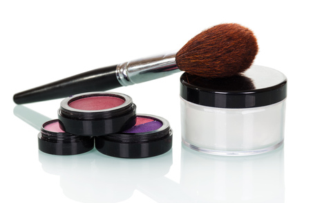 Cosmetic brush, shadows, lip gloss, blush and cream jar isolated on white background.の写真素材