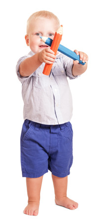 Charming boy holds two large pencil isolated on white background.の写真素材