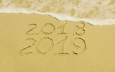 On the golden sand symbols 2018 2019, washes the sea water with foamの写真素材