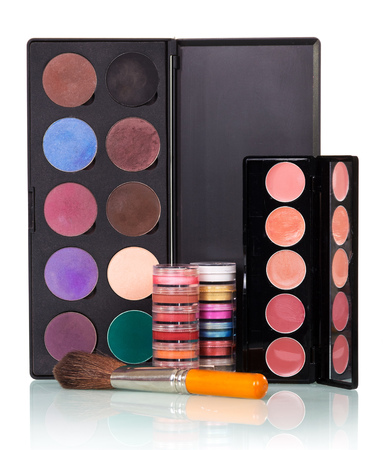 A set of eye shadow, lip gloss and brush for applying makeup isolated on white background.の写真素材