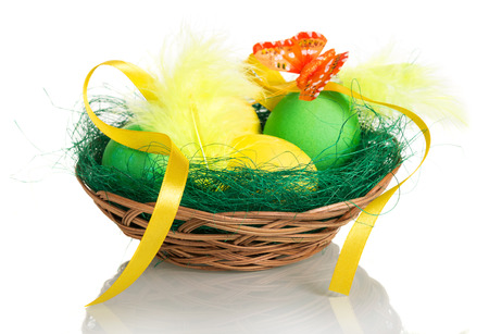 Colorful Easter eggs in a basket isolated on white background.の写真素材