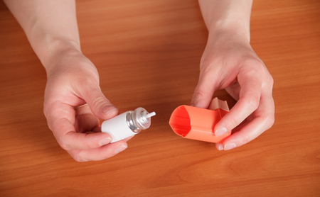 Pocket metered-dose inhaler for asthmatics in the handsの写真素材