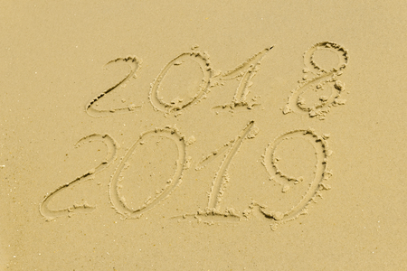 On the golden beach inscription on the sand 2018 2019, a holiday on the tropical coastの写真素材