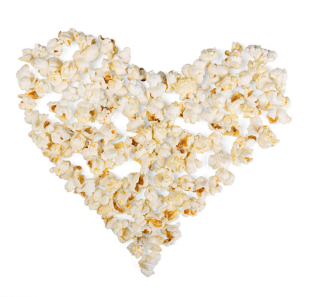 Popcorn, laid out in the shape of a heart on a white background.の写真素材