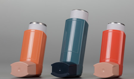 Three inhaler aerosol on the grey background.の写真素材