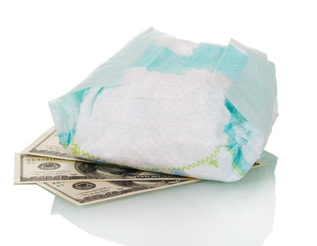Used disposable diaper and money isolated on white background.の写真素材