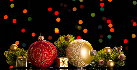 Large and small decorative balls, pine branches, small gift boxes, on a flickering backgroundの写真素材