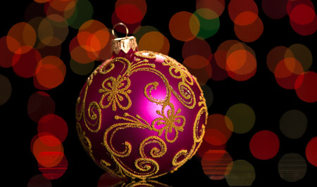 New Year's toy ball, decorated with pattern, on flickering backgroundの写真素材