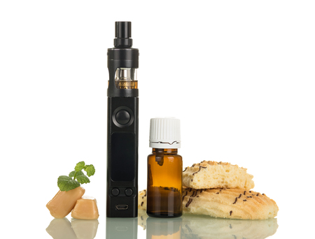 Electronic cigarette, bottle with fragrant smoking liquid and sweets, isolated on white backgroundの写真素材