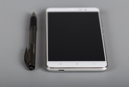 Modern multifunctional device and pen on gray backgroundの写真素材