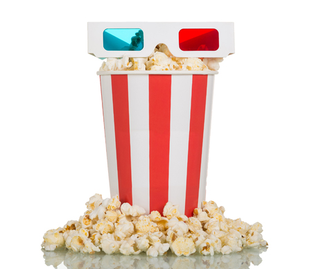 3D glasses, striped box, filled with popcorn and popcorn around isolated on white backgroundの写真素材