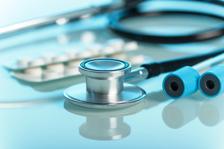Medical set for diagnosis, phonendoscope and test tube, on blue light backgroundの写真素材