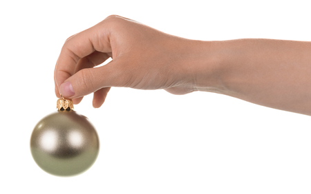Silvery small toy-ball is held by female hand, isolated on white backgroundの写真素材