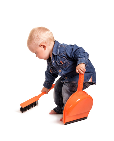 Little boy with broom and dustpan, isolated on white backgroundの写真素材