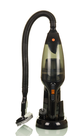 Small portable vacuum cleaner in stand and replaceable nozzle, isolated on white backgroundの写真素材