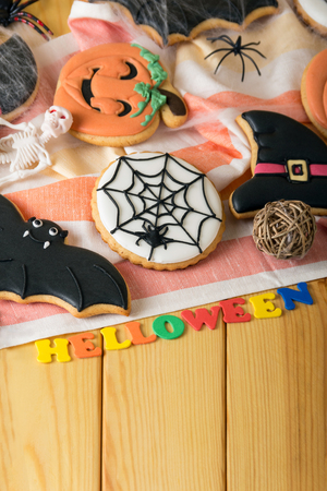 Attributes to the holiday, the inscription Halloween, on beige wooden tableの写真素材