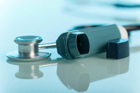Stethoscope and cure for asthma closeup on blue backgroundの写真素材
