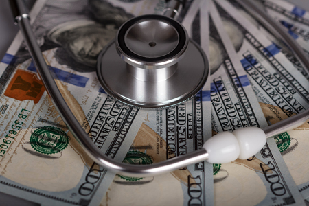 Phonendoscope - medical diagnostic tool on the background of moneyの写真素材