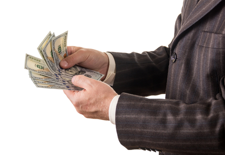 Businessman counts several hundred dollars isolated on white backgroundの写真素材