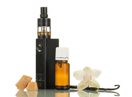 Fluid for smoking with vanilla scent and electronic cigarette isolated on white backgroundの写真素材