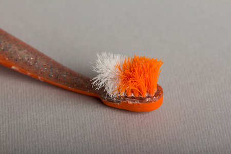 Old children's toothbrush is depicted on gray backgroundの写真素材