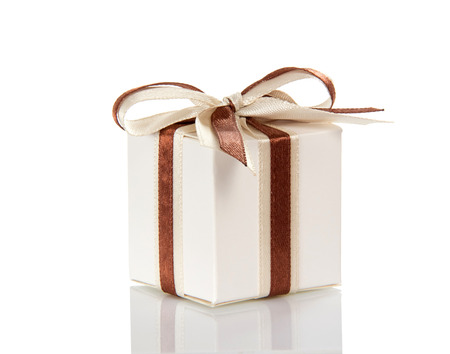 Box with gift, decorated with bow, isolated on white backgroundの写真素材
