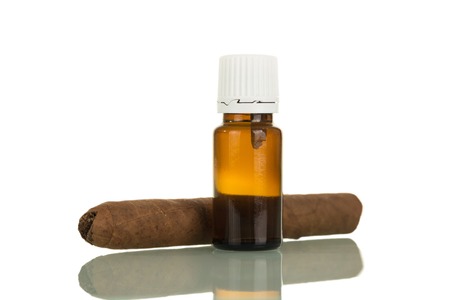 Bottle with liquid for smoking electronic cigarette, nearby cigar, isolated on white backgroundの写真素材