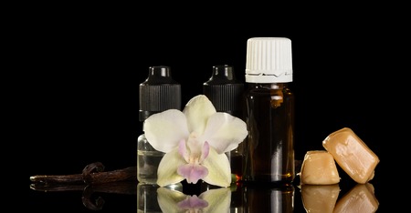 Set liquids Smoking area, flower and pod of vanilla, isolated on black backgroundの写真素材