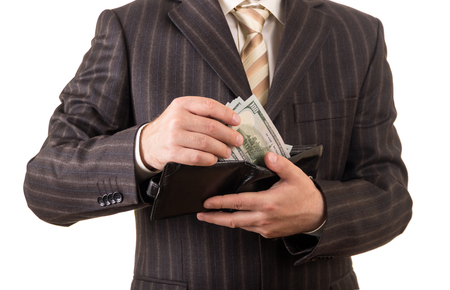 Successful businessman takes money from the wallet, isolated on white backgroundの写真素材