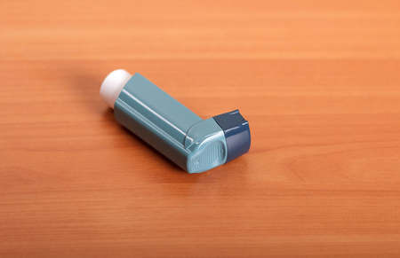 Small pocket inhaler on the background of wooden tableの写真素材