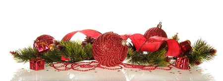 Small gifts and Christmas decorations of beads, ribbons and pine branches, beautifully laid out, isolated on white backgroundの写真素材