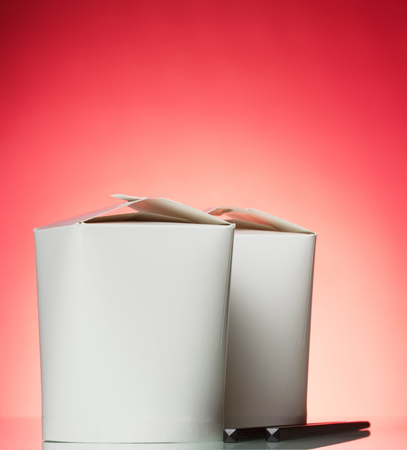 Boxes-wok for Chinese noodles and chopsticks, on pinkの写真素材