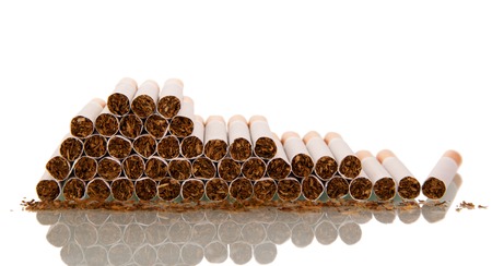 Lot of cigarettes, laid on top of each other isolated on whiteの写真素材