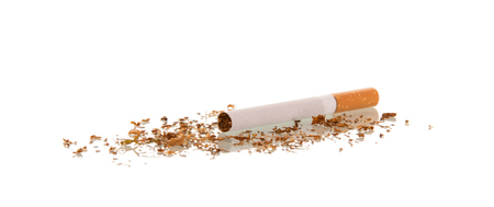 Unused cigarette and number of spill tobacco isolated on whiteの写真素材