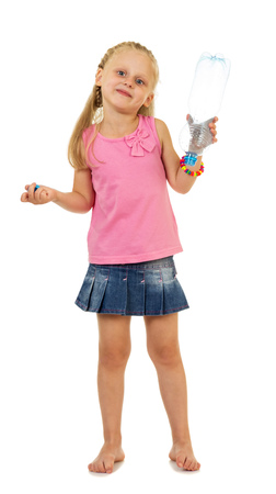 Little, charming girl holding an empty bottle isolated on whiteの写真素材