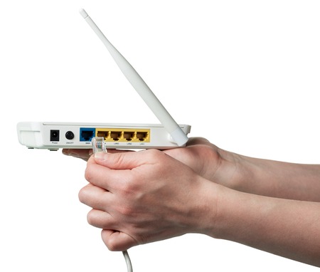 Connect the cable connector to modem, isolated on whiteの写真素材