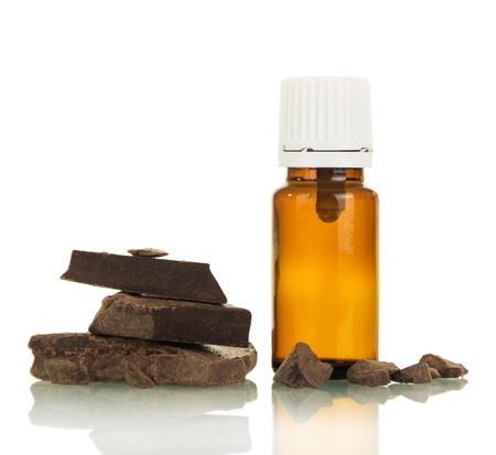 E-cigarette Smoking liquid, near pieces of chocolate isolated on whiteの写真素材