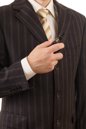 Man in suit holds in hand an electronic cigarette