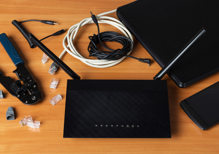 Modern devices and router, modem connection parts and tools on table
