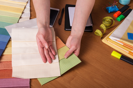 Choice of fabric for sewing, sewing accessories, on desktopの写真素材