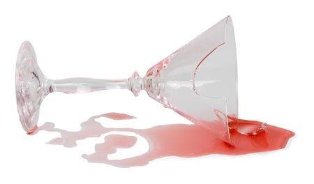 Glass of red wine is broken, isolated on whiteの写真素材