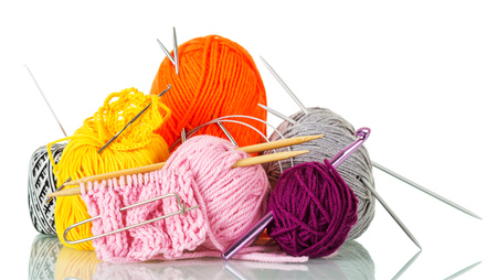Multicolored skeins of yarn, knitting needles, hooks and pins, finished patterns, isolated on whiteの写真素材
