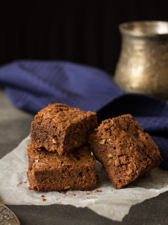 Appetizing pieces of chocolate cake with nuts on napkinの写真素材