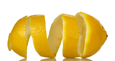 Lemon peel is removed in form of spiral, isolated on whiteの写真素材