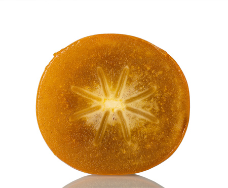 Cross-section of persimmon closeup isolated on whiteの写真素材