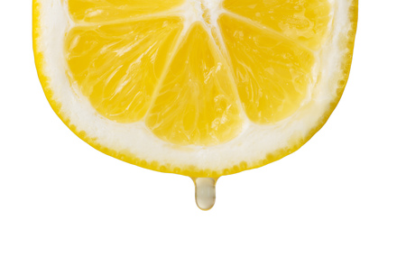 Cross section of lemon with drop of juice isolated on white. Closeupの写真素材