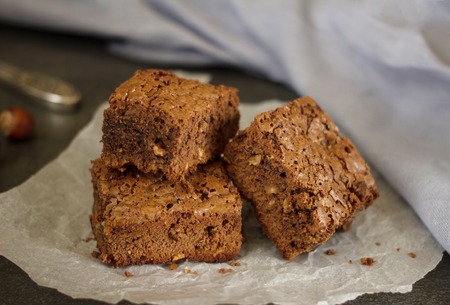 Three pieces of chocolate biscuit with hazelnut on paperの写真素材