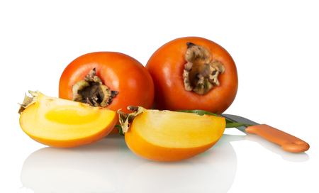 Fruit of persimmon, cut pieces and knife isolated on whiteの写真素材