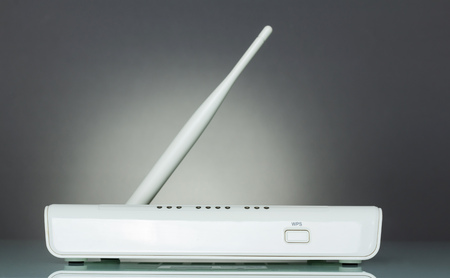 WiFi router device with secure wireless setup WPS, on grayの写真素材