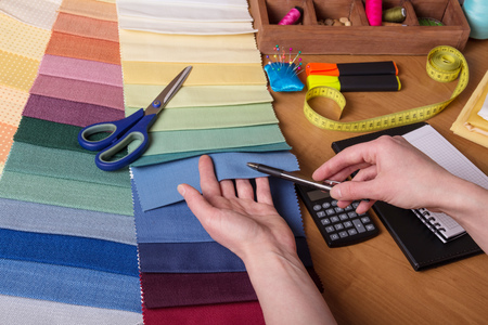 Choice of fabric for sewing, sewing accessories on tableの写真素材